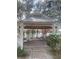 Community gazebo featuring brick floor, metal roof, white columns, and several picnic tables overlooking the lake at 3432 Westchester Square Blvd # 205, Orlando, FL 32835