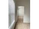 Hallway with a sunny window and blinds leads to the next room at 3432 Westchester Square Blvd # 205, Orlando, FL 32835
