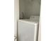 Laundry area with white washer, hookups and shelving at 3432 Westchester Square Blvd # 205, Orlando, FL 32835