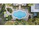 Aerial view of a large community pool with lounge chairs and landscaped surroundings at 3432 Westchester Square Blvd # 205, Orlando, FL 32835