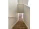 Carpeted staircase leading to the lower level of the home with neutral walls at 3432 Westchester Square Blvd # 205, Orlando, FL 32835