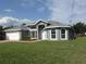 Beautiful single-story home with a well-manicured lawn and charming landscaping at 531 Rhodes Dr, Deland, FL 32720