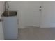 The laundry room has a stainless steel utility sink, and is painted white at 531 Rhodes Dr, Deland, FL 32720