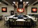 Modern bar area with a large countertop, multiple TVs, and a stylish stone accent wall at 333 Navarra Ln, Davenport, FL 33837