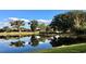 Picturesque pond reflecting trees and sky, creating a serene view of the community at 333 Navarra Ln, Davenport, FL 33837
