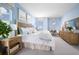 Bright bedroom with blue walls, natural light, and stylish furnishings at 2288 Sirena Ln, Mount Dora, FL 32757