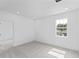 Bright, airy bedroom with a large window offering neighborhood views at 2288 Sirena Ln, Mount Dora, FL 32757