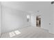 Large, bright bedroom featuring a large window and plush carpet at 2288 Sirena Ln, Mount Dora, FL 32757