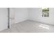 Cozy, light-filled bedroom with soft carpet, window view, and adjacent doorway at 2288 Sirena Ln, Mount Dora, FL 32757