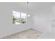 Dining area with wood floors, decorative light fixture, and window view at 2288 Sirena Ln, Mount Dora, FL 32757