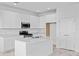 Bright, modern kitchen with white cabinets, stainless steel appliances, and center island at 2288 Sirena Ln, Mount Dora, FL 32757