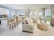 Open-concept living room featuring stylish furniture, modern kitchen, and a dining area at 2288 Sirena Ln, Mount Dora, FL 32757