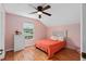 Bright bedroom with wood floors, ceiling fan, window and a queen size bed at 65 Keeble Ave, Debary, FL 32713