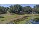 An aerial view of the property shows the homes nestled amongst mature trees with a peaceful lake in the backyard at 4808 Anderson Rd, Orlando, FL 32812