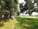 The picturesque backyard offers serene lake views, mature trees, and a charming home, creating a peaceful retreat at 4808 Anderson Rd, Orlando, FL 32812