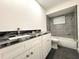 Bathroom featuring granite countertops, double sink vanity, and tiled shower with glass door at 4808 Anderson Rd, Orlando, FL 32812