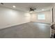 Spacious bedroom featuring tile floors, a ceiling fan, and bright windows at 4808 Anderson Rd, Orlando, FL 32812