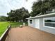 A deck connects the home to the outdoors offering a relaxing space to enjoy the green grass and lake view at 4808 Anderson Rd, Orlando, FL 32812