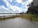 A spacious deck overlooks a serene lake, offering a perfect spot for relaxation and outdoor enjoyment at 4808 Anderson Rd, Orlando, FL 32812