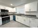 A stylish kitchen features granite countertops, stainless steel appliances, and ample cabinet space for modern living at 4808 Anderson Rd, Orlando, FL 32812