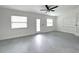 A well-lit living room features tile floors and several windows overlooking the lush yard and calming lake at 4808 Anderson Rd, Orlando, FL 32812