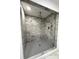 Luxurious shower stall featuring stunning marble-like tile and a modern rainfall shower head at 4808 Anderson Rd, Orlando, FL 32812