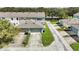 Aerial view of townhomes showing driveway, landscaping, and proximity to water at 6364 Lake Smith Cir, Windermere, FL 34786