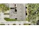 An aerial view of a home showcasing the roof, green lawn, and surrounding trees at 6364 Lake Smith Cir, Windermere, FL 34786