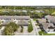 An aerial view of townhomes situated beside a scenic lake, surrounded by lush greenery at 6364 Lake Smith Cir, Windermere, FL 34786