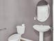 Powder room features pedestal sink, oval mirror and neutral paint color at 6364 Lake Smith Cir, Windermere, FL 34786