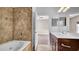 Bathroom with soaking tub, tiled shower, and vanity with modern fixtures at 6364 Lake Smith Cir, Windermere, FL 34786