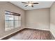 Bedroom featuring hardwood floors, a modern ceiling fan, and a large window at 6364 Lake Smith Cir, Windermere, FL 34786