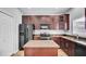 Kitchen features stainless steel appliances, island, granite countertops, and ample cabinets at 6364 Lake Smith Cir, Windermere, FL 34786