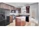 Stylish kitchen with stainless steel appliances, granite countertops, tile floors, and island at 6364 Lake Smith Cir, Windermere, FL 34786