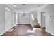 Well-lit living room with beautiful flooring, stylish light fixtures, and staircase at 6364 Lake Smith Cir, Windermere, FL 34786