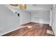 Open-concept living room with hardwood floors, modern lighting, and floating shelves at 6364 Lake Smith Cir, Windermere, FL 34786