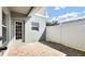 Back patio with privacy fence, brick pavers, and back door access at 6364 Lake Smith Cir, Windermere, FL 34786