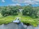 Aerial view of waterfront property with a private dock and lush greenery at 9 Stone Gate N, Longwood, FL 32779