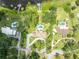 Overhead view of multiple residential homes, pools, and private docks along a scenic lake at 9 Stone Gate N, Longwood, FL 32779