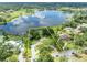Aerial view of a lakefront estate with a defined property line, lush landscaping, and a private dock at 9 Stone Gate N, Longwood, FL 32779