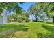 Lush backyard featuring mature trees, leading to the waterfront with room for entertaining at 9 Stone Gate N, Longwood, FL 32779
