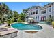 Beautiful backyard pool is accompanied by lush landscaping, patio dining, and a large house at 9 Stone Gate N, Longwood, FL 32779