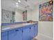 Bathroom featuring a double vanity with under cabinet storage and decorative art at 9 Stone Gate N, Longwood, FL 32779