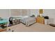 Neutral bedroom offers a calm aesthetic with soft carpet, window light, and gray and white bedding at 9 Stone Gate N, Longwood, FL 32779