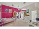 Bright bedroom features a unique lofted bed, vibrant pink walls, and a cozy study area at 9 Stone Gate N, Longwood, FL 32779