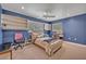 Inviting bedroom with blue walls, built-in shelves, and natural light creating a relaxing atmosphere at 9 Stone Gate N, Longwood, FL 32779