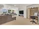 Spacious living room with large windows offering scenic lake views and comfortable seating arrangements at 9 Stone Gate N, Longwood, FL 32779