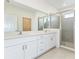 Elegant bathroom with double vanity, walk-in shower, and large mirror at 3054 Suraj Cir, Tavares, FL 32778
