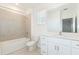Bright bathroom featuring a tub-shower combo, a vanity with a white quartz countertop, and gray tile flooring at 3054 Suraj Cir, Tavares, FL 32778