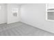 Bright bedroom featuring neutral carpet, white walls, and natural light from the windows at 3054 Suraj Cir, Tavares, FL 32778